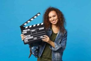 young african american girl teen student denim clothes backpack hold clapper isolated blue wall 365776 281 1